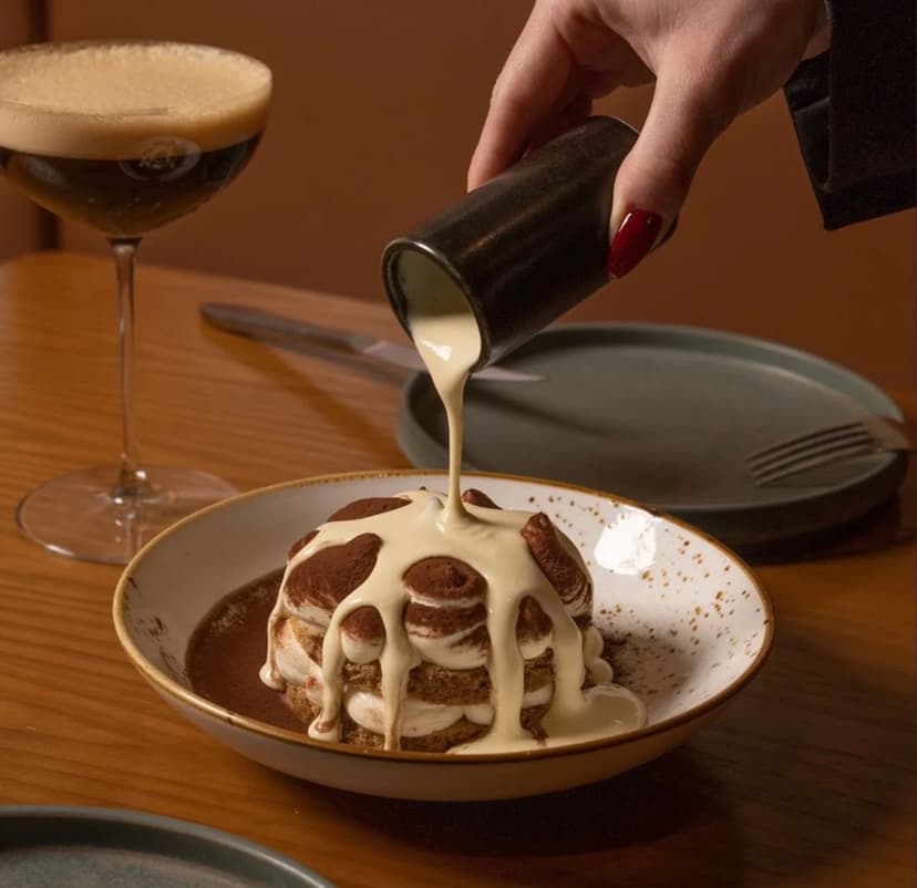 Filo tiramisu finished tableside with a pour of cafe liquor, served beside an espresso martini