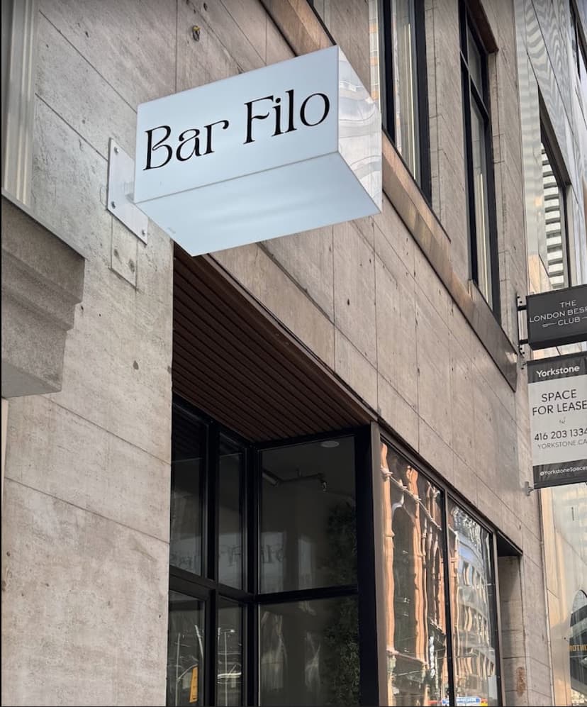 The Bar Filo storefront sign, set in an elegant serif above the entrance on Yonge Street